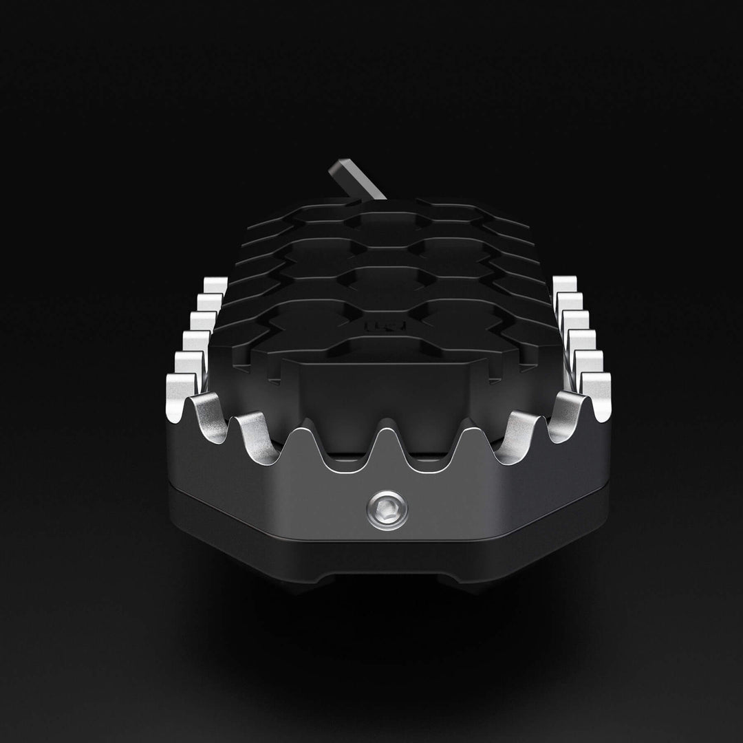 Image of one motorcycle foot peg with rubber to protect a boot